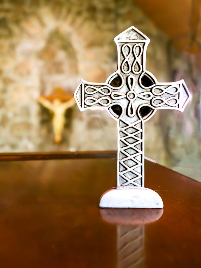 Cross on table, crucifix behind